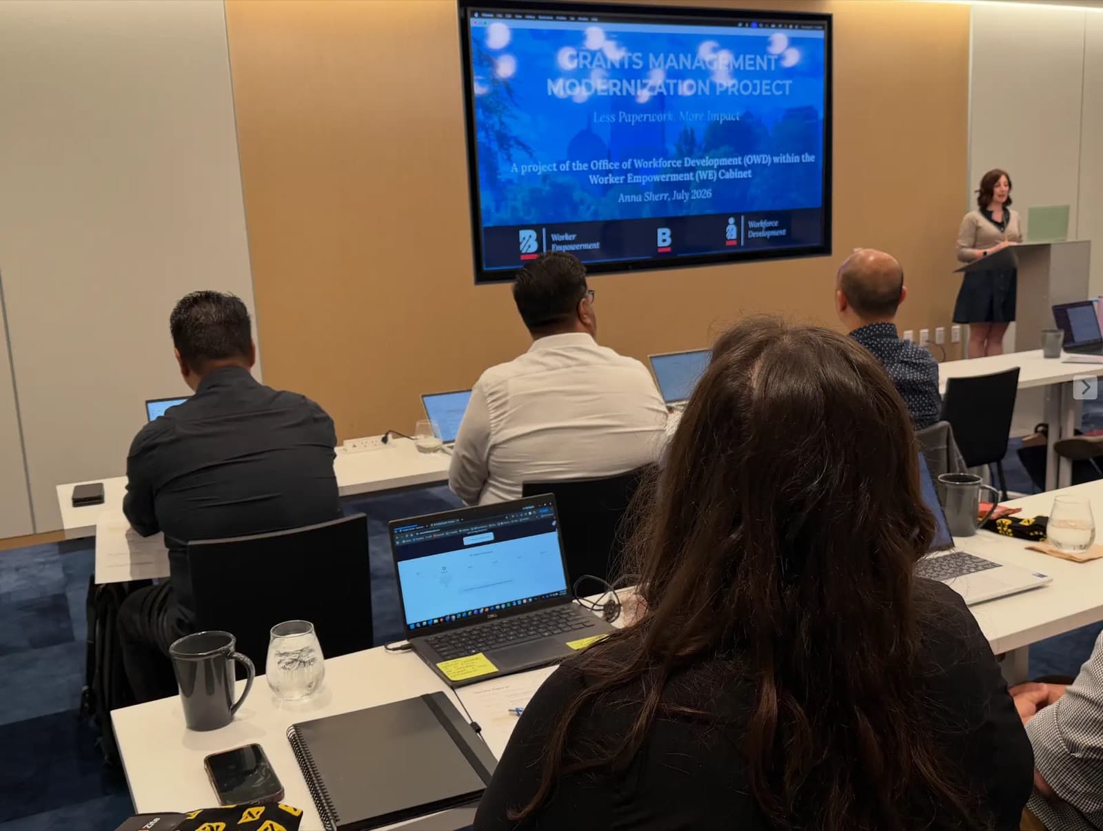 Anna Sherr presenting Boston's grants management project to a room of attendees